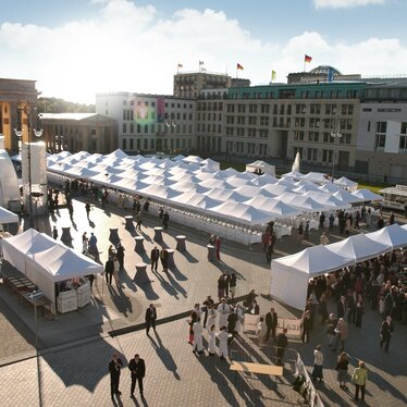 White folding gazebos 8x4 and 6x4 m at a large event Ecotent White folding gazebos 8x4 and 6x4 m at a large event with many people at Alexanderplatz in Berlin